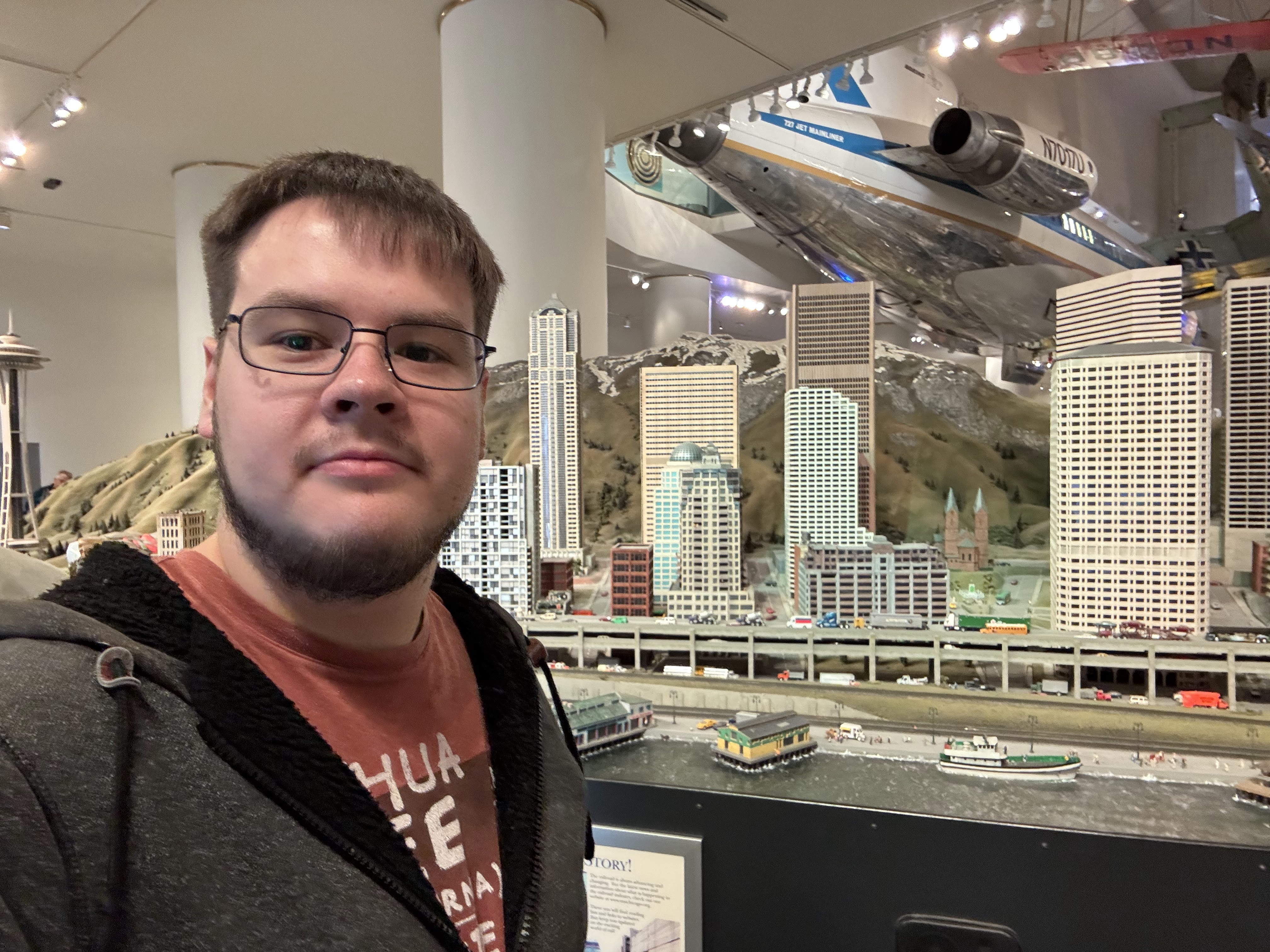 Adam standing in front of a scale model of Chicago at the griffin museum. 
